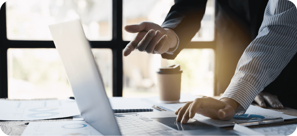 PC画面を覗き込むスタッフのイメージ。