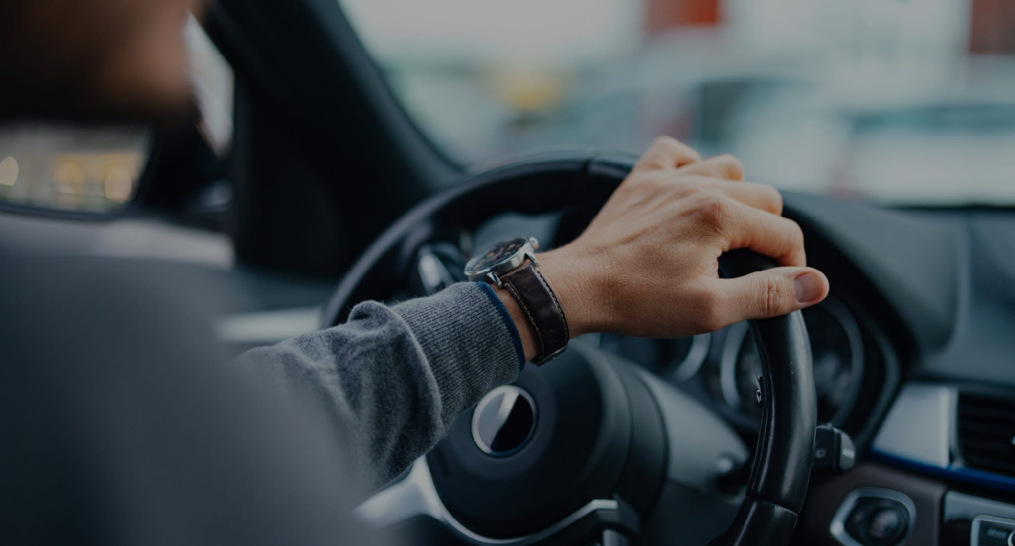 車のハンドルを握り、目的地へと走行するドライバーの手元のイメージ。